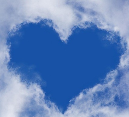 Heart shape of sky between clouds